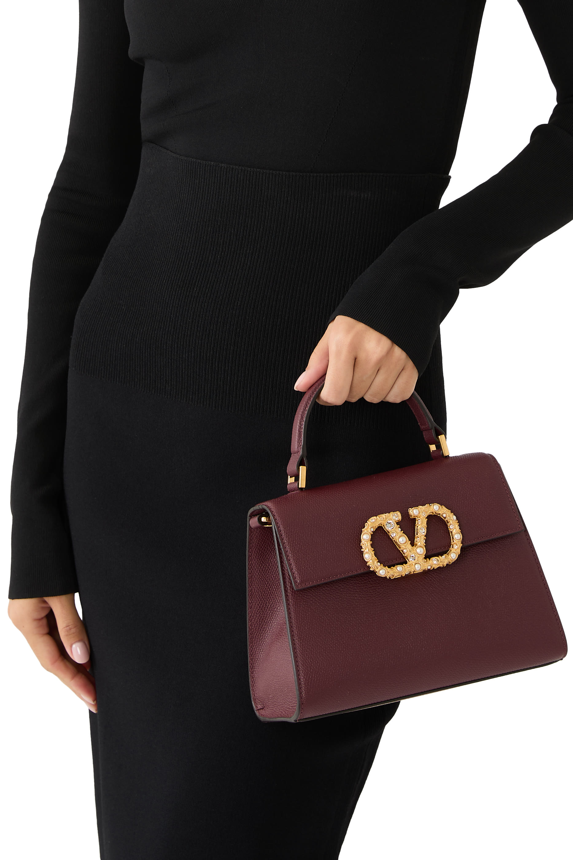 حقيبة يد صغيرة بحلية شعار الماركة المرصعة بأحجار